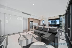 a living room with a couch and a table at Bright & Spacious 2BR in Prime CBD Location in Perth +58 photos