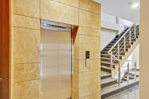 a elevator in a building with stairs in the background at Townhouse Golden Frame near sec 62 noida in Ghaziabad