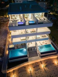 a building with two swimming pools on top of it at NEW Sunset Suite in Povljana