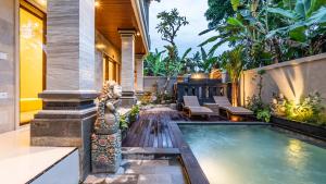 a house with a swimming pool in a yard at Lavana Ubud in Ubud