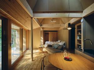 a living room with a table and a couch at SANU 2nd Home 八ヶ岳 3rd in Hokuto