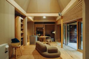 een woonkamer met een bank en een tafel bij SANU 2nd Home 八ヶ岳 3rd in Hokuto