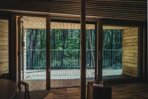 a room with a view of a screened in porch at SANU 2nd Home 八ヶ岳 3rd in Hokuto
