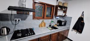 a kitchen with a stove and a counter top at Badulla Bliss in Badulla