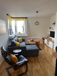 a living room with a couch and a table at Apartman 8 Panorama sa garažom in Bjelašnica