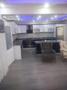 a large kitchen with a couch and a chair at Living House in Salihli