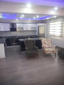 a kitchen with two chairs and a table in a room at Living House in Salihli +47 photos