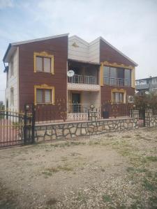 a house with a fence in front of it at Living House in Salihli