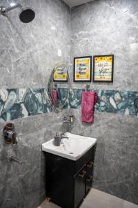 a bathroom with a sink and a shower at Blissful Escape Dehradun in Dehradun +16 photos