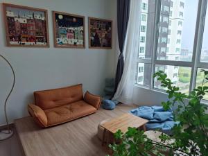 a living room with a couch and a table and a window at Amber Cove - Luxury Design By Luxpro Management - 6~7 pax in Melaka