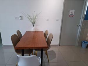 a dining room table with chairs and a vase on it at Amber Cove - Luxury Design By Luxpro Management - 6~7 pax in Melaka +215 photos