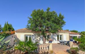 a house with a tree and a patio at Villa Avec Piscine 1 in Roquebrune-sur-Argens