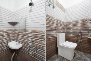 a bathroom with a toilet and a sink at FabHotel Jyotish Bhawan in Ayodhya +15 photos