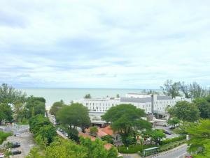 arial view of a building with the ocean in the background at Partial Seaview with Wifi, Batu Ferringhi in Batu Ferringhi