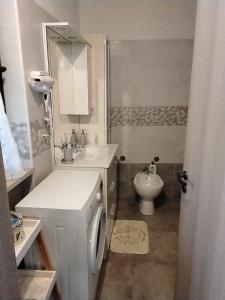 a white bathroom with a sink and a toilet at B&B Oasi di pace in Rocca deʼGiorgi
