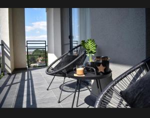 a balcony with a table with a plant on it at Sunset view Armoniei Apartament in Timişoara