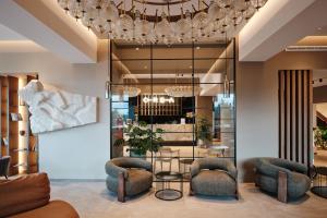 泽勒兹纳·鲁达OREA Resort Horizont Šumava的大堂配有桌椅和吊灯。