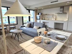 a living room with a blue couch and a table at Playa Sardinero - Little Homes 1-2-3-5 in Santander