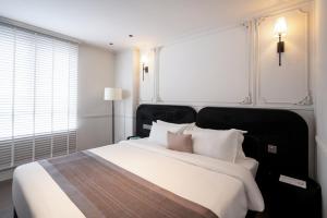 Postel nebo postele na pokoji v ubytování AMANA Boutique Hotel - Than Van Nhiep + 79 fotografií