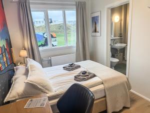 a small bedroom with a bed and a window at The Stykkishólmur Inn by Ourhotels in Stykkishólmur