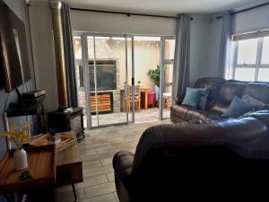 a living room with a couch and a table at Muize at Sea in Marina da Gama