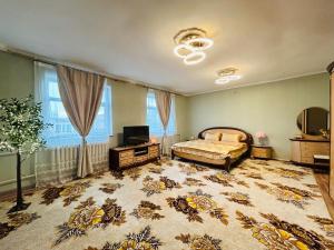 a bedroom with a bed and a television in it at Mandakh Naran Guest House in Dzuunmod