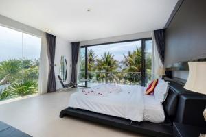 a bedroom with a large bed and a large window at Villa D3 Private - In Great Location Front Of The Sea in Vung Tau +65 photos