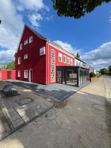 a red building on a street at Delikanto Apartments in Unterlüß