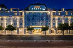 a hotel with a lit up facade at night at Hesperia Córdoba in Córdoba +56 photos