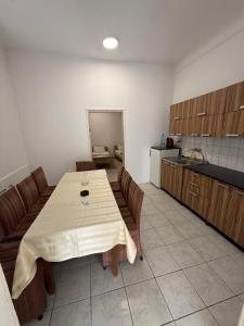 a kitchen with a table and chairs in a room at Guest house Dunavac in Kovin