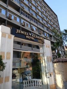 a building with a sign for a luxury embassy hotel at Jewel Al Nasr Hotel & Apartments in Cairo