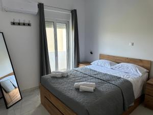 a bedroom with a bed with two towels on it at Casa Platania in Eleoúsa +8 photos