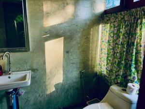 a bathroom with a sink and a toilet and a window at Latehouse bar อัมพวา in Ban Nong Chaeng +24 photos