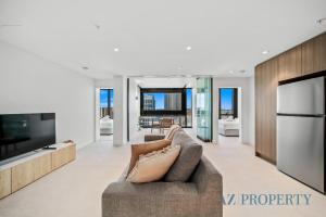 a living room with a couch and a television at Brand new Luxurious 2 Bedroom Perth CBD in Perth +60 photos