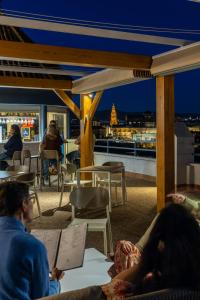 a group of people sitting on the roof of a building at Hesperia Córdoba in Córdoba