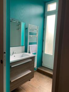 a bathroom with a sink and a mirror at La Tour du Maine in Marmande +34 photos