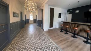 a hallway with a room with a chandelier at La Tour du Maine in Marmande