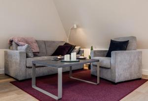 a living room with a couch and a coffee table at Haus Svenja in Westerland (Sylt)