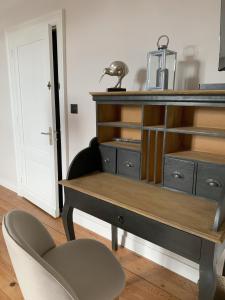 a desk and a chair in a room at La Tour du Maine in Marmande