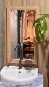 a sink in a bathroom with a mirror and a table at LoftVibes San Juan - 1 in San Juan