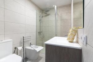 a bathroom with a sink and a toilet and a shower at rentafive - Nuevo - Centro - A/C in Santa Pola +19 photos