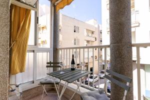 a bottle of wine on a table on a balcony at rentafive - Nuevo - Centro - A/C in Santa Pola
