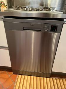 a stainless steel stove top oven in a kitchen at La terrazzina nel borgo apt dimora storica toscana pool&garden in Lano
