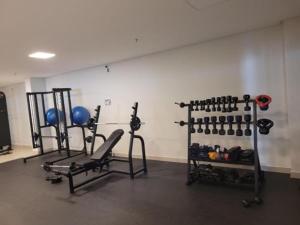 a gym with two rows of exercise bikes and weights at Park Veredas Flat 310 Premium in Rio Quente