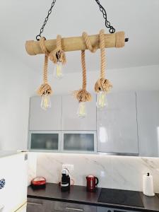 a hanging chandelier in a kitchen with a counter at Κυκλαδίτικο σπίτι με θέα Villa Mimika in Perissa +63 photos