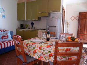 a kitchen with a table with a bottle of wine at Casa Luciana in Mergozzo