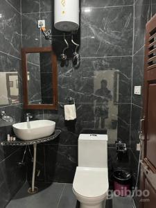 a bathroom with a white toilet and a sink at Hostel sakura Jaisalmer in Jaisalmer