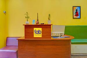 a office with a desk with a computer on it at FabHotel Martine's Residency - French Colony, 5 Mins from Rock Beach in Puducherry