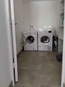 a laundry room with a washing machine and a washer at Le Bohème par Vosges Sérénité in Épinal
