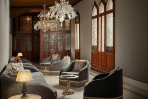 a living room with couches and chairs and a chandelier at Hotel Gabrielli Venezia - Starhotels Collezione in Venice +125 photos